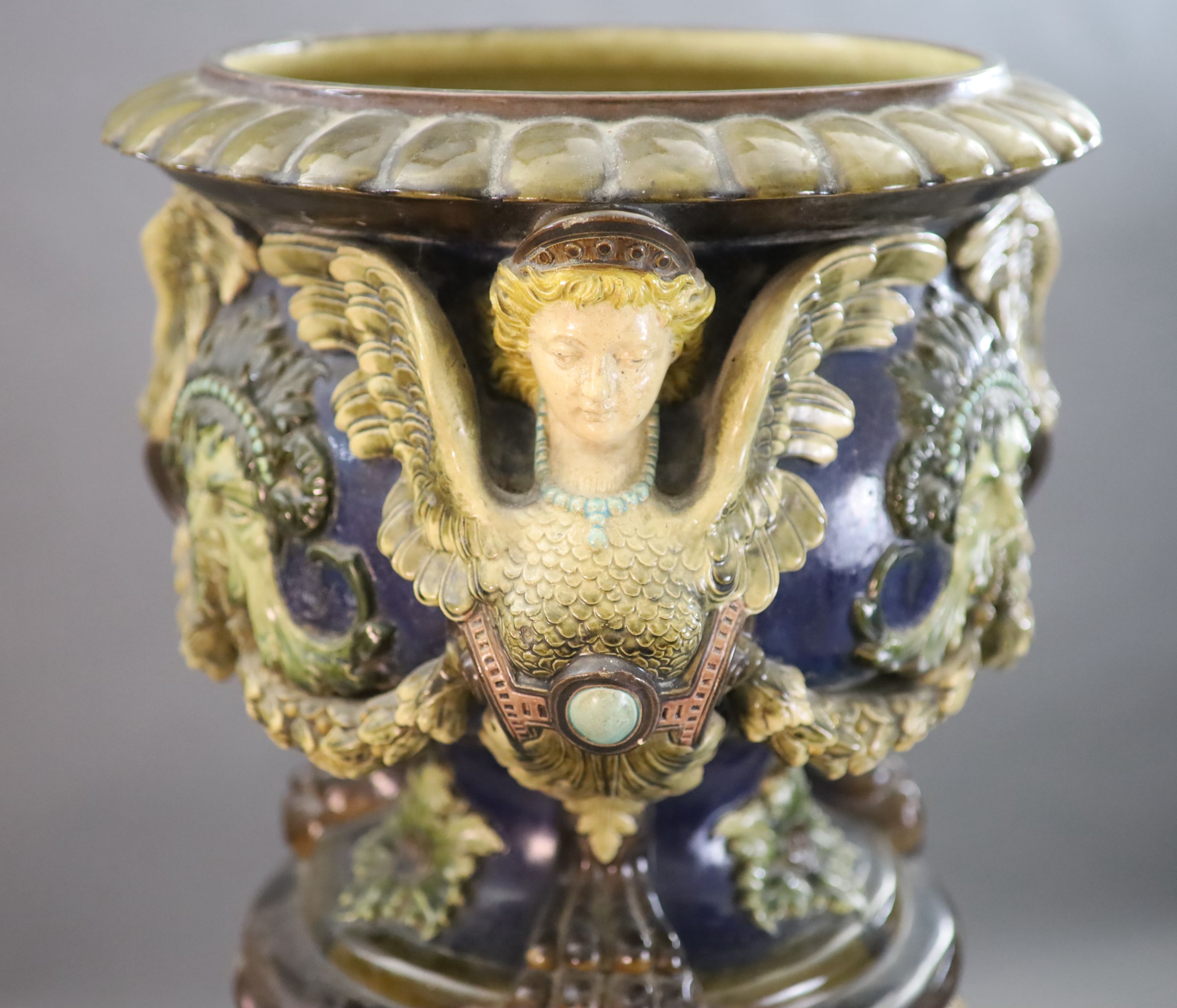 A Continental Palissy style grotesque pottery jardiniere and associated pedestal, late 19th century, total height 134cm